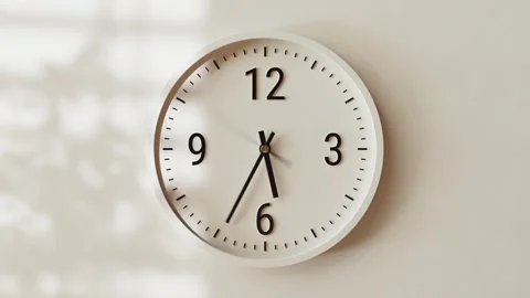Time-lapse white classic wall clock, textured light beige concrete background Stock Footage 300878815