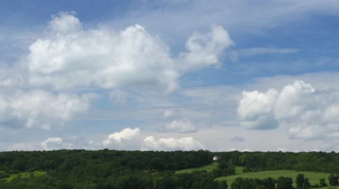Time lapse of white clouds and green hills Stock Footage 53485629