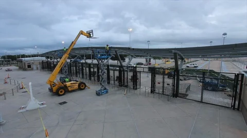 Time-lapse of white clouds and construction of sports stadium Stock Footage 105423083