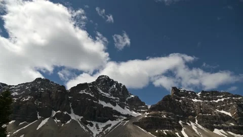Time lapse of white clouds building in a dark blue sky and mountain Stock Footage 134819004