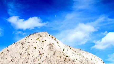 Time Lapse, White Clouds On Dark Blue Sky Over Limestone Heap Video stock 115510091