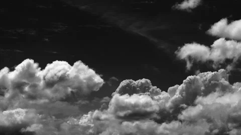 Time-lapse of white clouds drift quickly against a pure black background Stock Footage 336740929