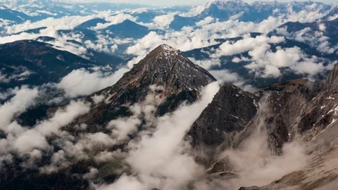 Time lapse of white clouds floating over the rocky mountain ranges 스톡 동영상 77815481
