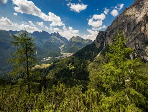 Time-lapse of white clouds floating over beautiful mountains in forest Stock Footage 107942957