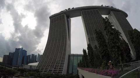 Time lapse of white clouds flying over Marina Bay Sands in downtown Singapore Stock Footage 113546124