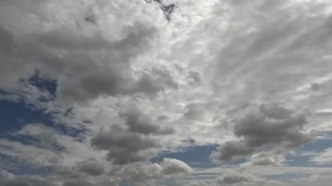 Time Lapse White Clouds Flying Moving in Blue Sky with Sun Rays background Stock Footage 253665601