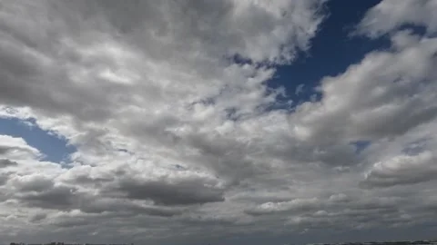 Time Lapse White Clouds Flying Moving in Blue Sky with Sun Rays background Stock Footage 253665937
