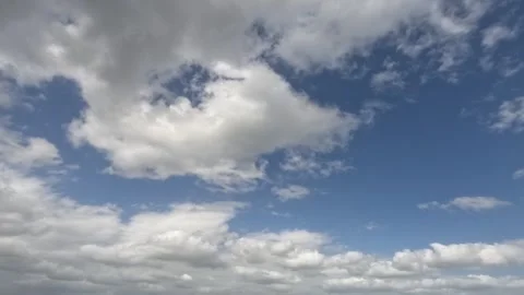 Time Lapse White Clouds Flying Moving in Blue Sky with Sun Rays background Stock Footage 253665970