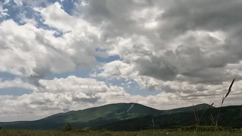 Time Lapse White Clouds Flying Moving in Blue Sky with Sun Rays background Stock Footage 253665982