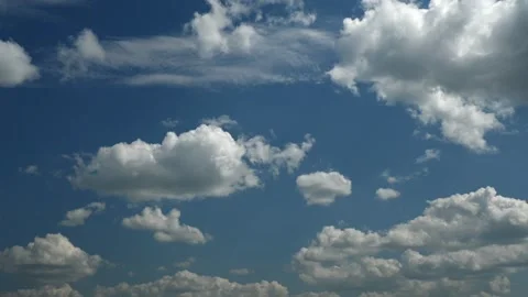 Time lapse of white clouds forming and moving in a blue sky.  Stock Footage 247412337