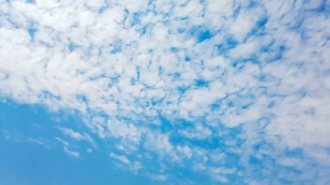 Time lapse of white clouds getting away under blue sky Stock Footage 128289962