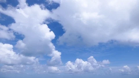 A time lapse of white clouds moving across a blue sky. 库存影片 77874235