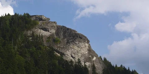 Time-lapse of white clouds moving over Devil's Courthouse mountain Stock Footage 103776889