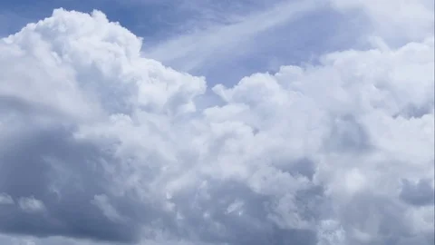 A time lapse of white clouds moving across a blue sky. Stock-Footage 107461566