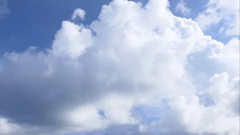 A time lapse of white clouds moving across a blue sky. Stock-Footage 107597194