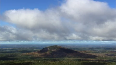 Time-lapse of white clouds moving over the hill and beautiful green landscape Stock Footage 109136300