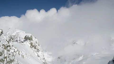 Time-lapse of white clouds moving over snow covered mountains Stock Footage 113219414