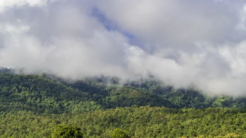 Time lapse of white clouds moving over mountains Stock Footage 218412253