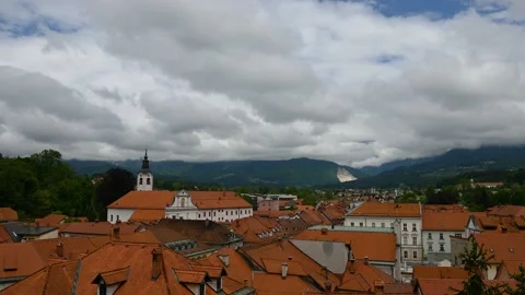 Time lapse of white clouds moving over small medieval town Kamnik Stock Footage 219689887