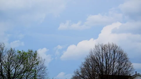 Time lapse of white clouds moving across deep blue sky Stock Footage 334051519