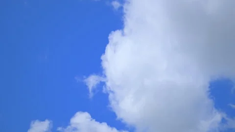 Time lapse of white clouds moving across deep blue sky during bright sunny day. Stock Footage 335950132