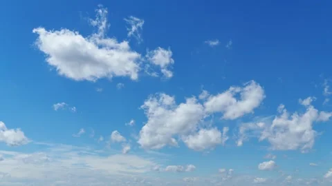 Time lapse of white clouds moving across a bright blue sky background Stock Footage 340101279