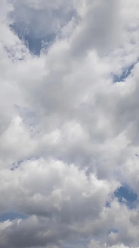 Time lapse of white clouds moving across blue sky on sunny day Stock Footage 345581785
