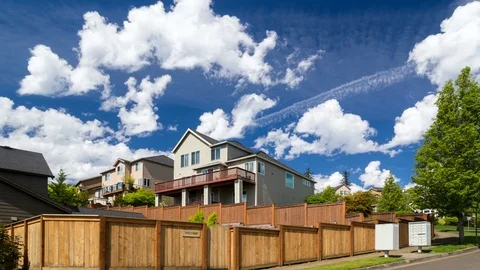 Time lapse of white clouds over luxury homes in Happy Valley OR one sunny day 4k Stock Footage 75487328