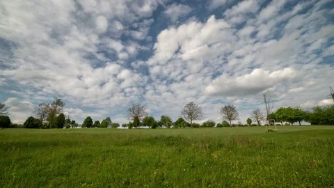 Time lapse with white clouds over a meadow Stock Footage 132298303