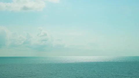 Time Lapse of White Clouds over the Sea in Sunlight. Blue Sunny Sky Ocean Water  Video stock 250962978