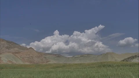 Time lapse, white clouds passing over green hills. Stockbeeldmateriaal 90357568