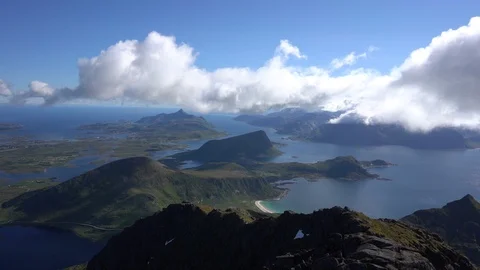 Time-lapse of white clouds passing over the coastal mountain 스톡 동영상 114881461