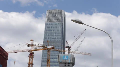 Time Lapse of white clouds past a building in Beijing's CBD Stock Footage 51140960