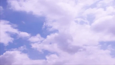 Time lapse white clouds sail across a blue sky Stock Footage 246172403