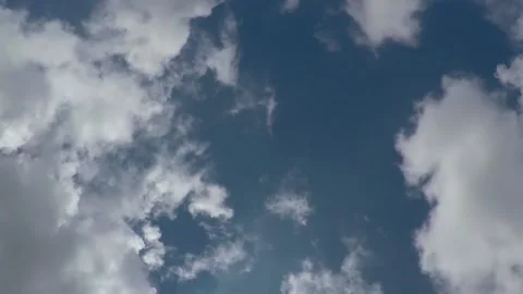 Time lapse of white clouds on sunny blue sky Stock Footage 138890325