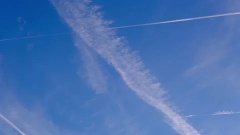 Time-lapse of the white contrail trails of the planes in the morning blue sky. Stock Footage 208917133