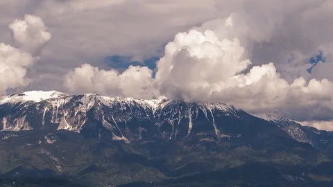 Time lapse white cumulus clouds forming and rolling over Alps mountains Stock Footage 120990274