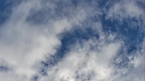 Time Lapse of White fluffy clouds in the blue sky background Stock Footage 94440074