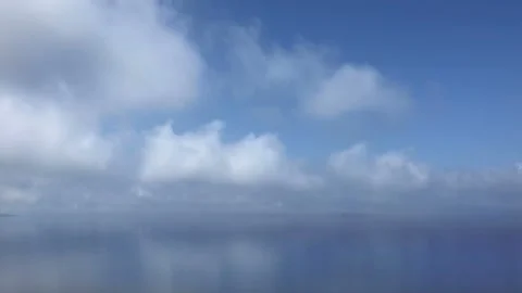 Time lapse of white fluffy clouds over blue sky Stock Footage 94859848