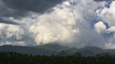 Time-lapse of white fluffy clouds moving over mountains Stock Footage 107578836