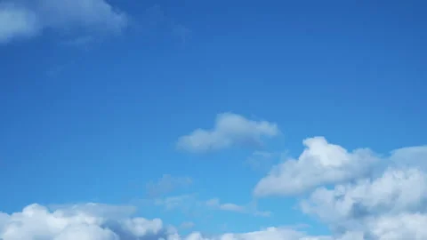 Time lapse of white fluffy clouds on a blue sky. Screen saver heaven Stock Footage 130998793