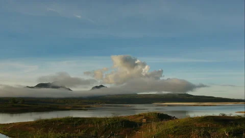Time Lapse of White fluffy clouds in the blue sky over the lake Stock Footage 134050072