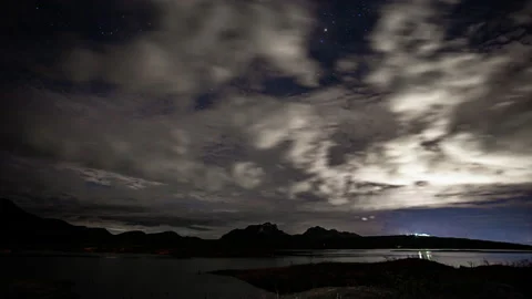Time-lapse of white fluffy clouds in the night sky Stock Footage 134050821