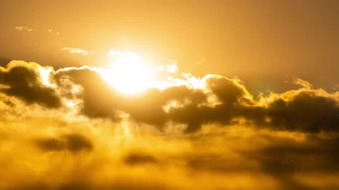 Time Lapse of White Fluffy Clouds Floating in a Dright Orange Sunset Stock Footage 172566568