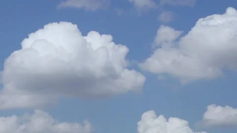 Time Lapse of White Fluffy Puffy Clouds Floating across the Blue Sky. Clouds and Video stock 136746340