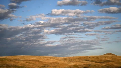 Time lapse of white to gray clouds above an autumn badlands setting Stock Footage 286903166