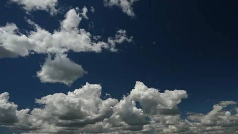 Time lapse of white to grey cumulus clouds moving towards the viewer  Stock Footage 285421497