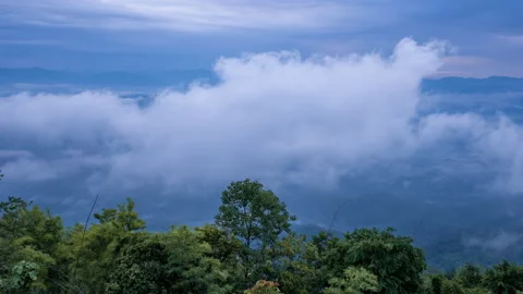 Time lapse of white morning clouds and fogs moving across mountains Stock Footage 219542573
