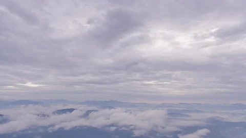 Time lapse of white morning clouds and fogs moving across mountains Stock Footage 219543759