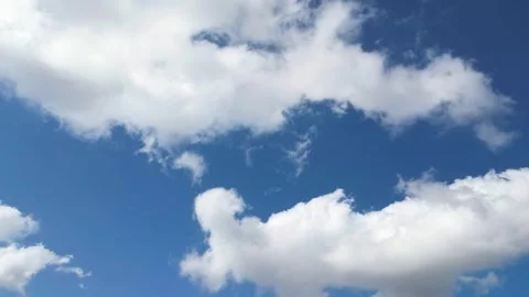 Time-lapse of a White Puffy Cloud in a Clear Blue Sky Stock Footage 321014683